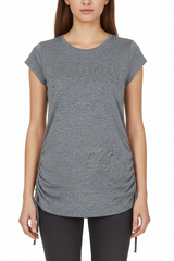 Woman wearing a gray t-shirt with a brand logo on a white background